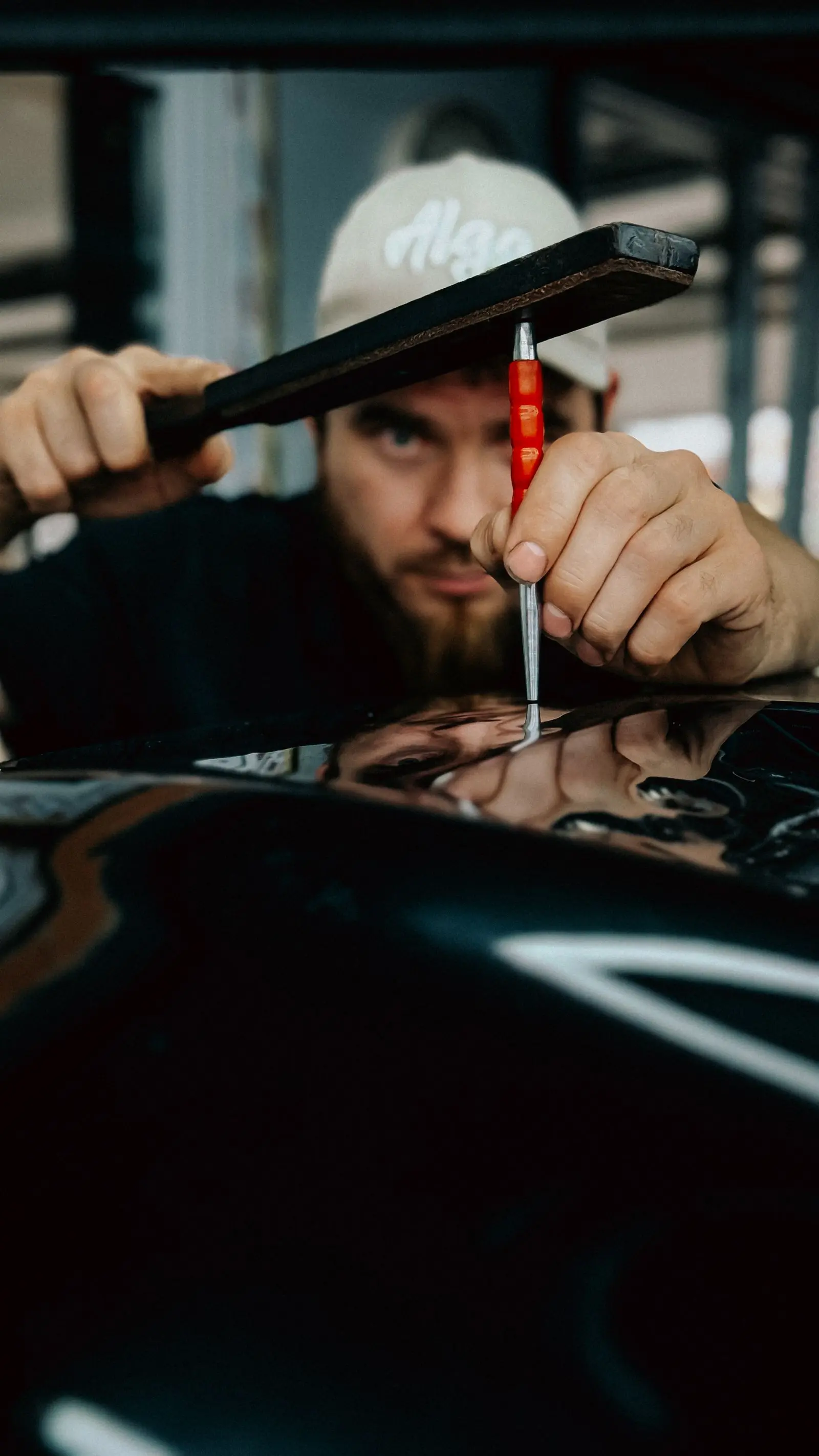 Técnico revisa una abolladura en la carrocería de un automóvil